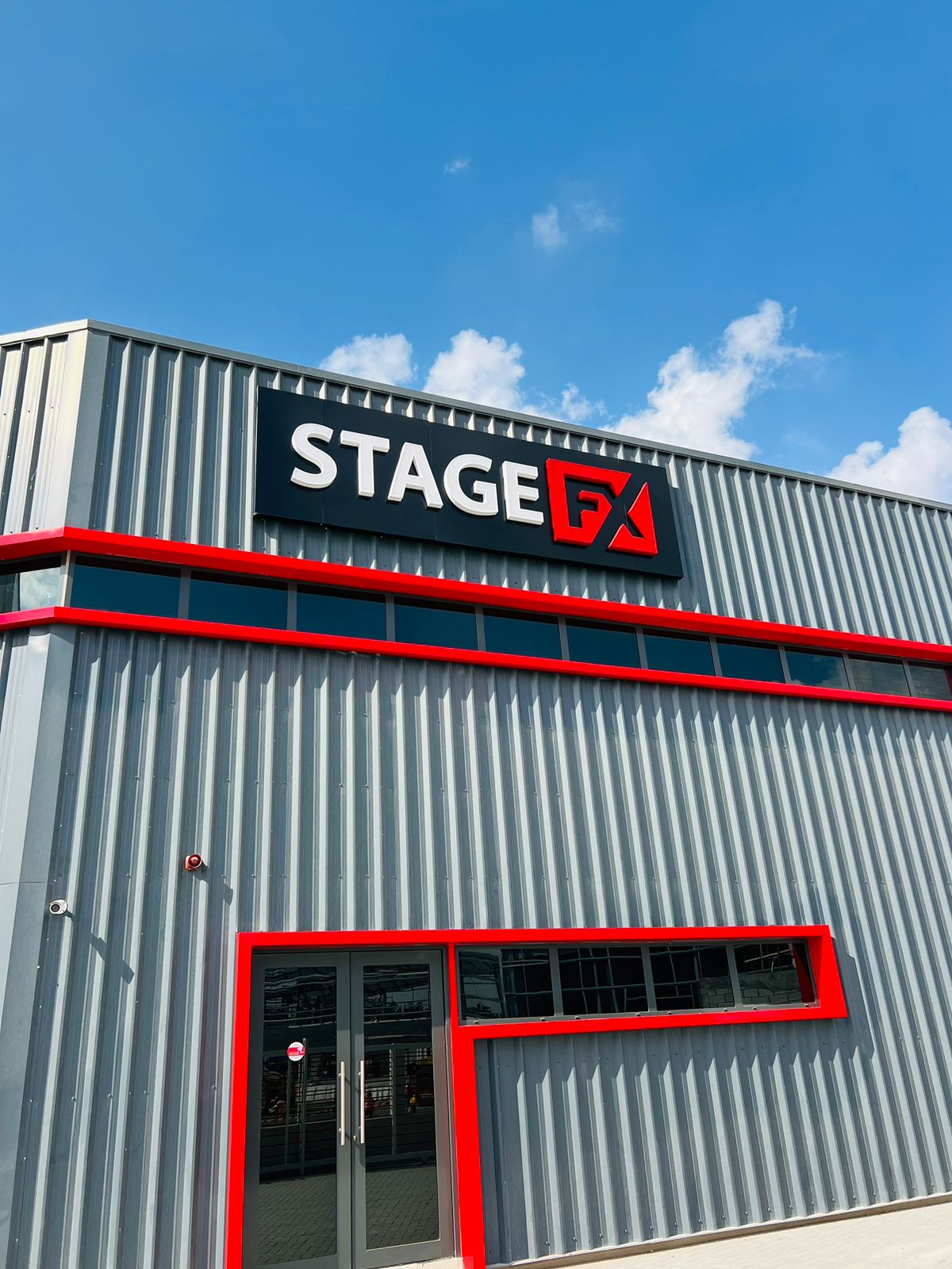 Stage FX exterior building sign with red facade trim