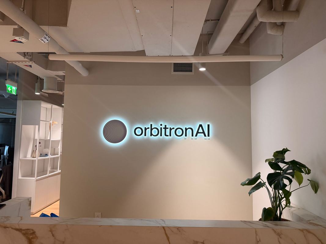 OrbitronAI illuminated reception sign